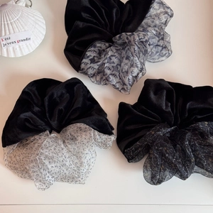Detailed close-up of velvet and printed organza scrunchies with elegant shell decor