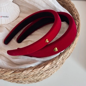 Set of two red velvet padded headbands with gold heart detail on woven linen fabric