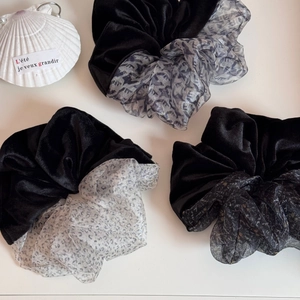 Detailed shot of velvet and organza scrunchies with leopard print and contrast texture