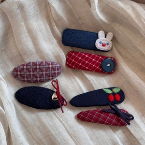 Detail of six-piece plaid and denim hair clips with embroidered rabbits and cherry motifs