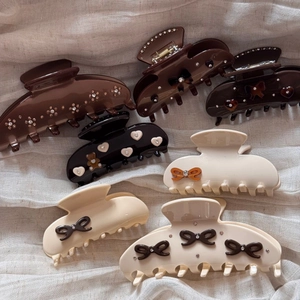 Elegant acetate claw clips with rhinestone bows and bear designs for hair styling