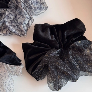 Detailed close-up of velvet patchwork scrunchies with leopard print and mesh texture