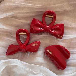 Three-piece red bow hair claw clips set in glossy resin with elegant gold metal springs