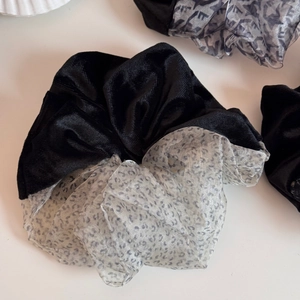 Detailed shot of bicolor velvet and leopard print mesh scrunchie hair accessory
