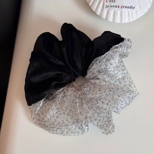 Detailed close-up of velvet and leopard print mesh spliced oversized hair scrunchie