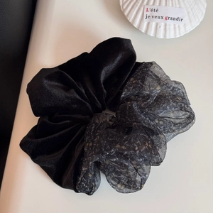 Detail of velvet and floral organza hair scrunchie with chic bicolor design