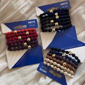 Detail of high-elasticity ribbed hair ties with decorative gold beads in various colors