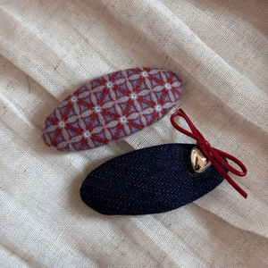 Detail of plaid wool hair clip and denim bow hairpin with metal heart pendant
