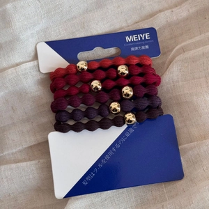 Detailed set of 5 elastic hair ties in gradient red tones with gold metallic beads