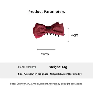 Dettaglio molletta a fiocco rosso a righe con dimensioni 13cm x 6cm e peso di 41g