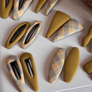 Detail of fabric BB hair clips with vintage plaid patterns in various geometric shapes