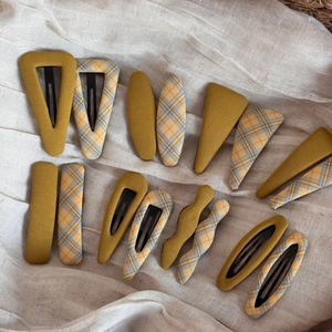 Detail view of 14pcs Korean fabric plaid hair clips in yellow and blue checkered patterns
