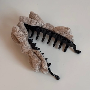 Detail view of beige lace bow hair clips with anti-slip toothed comb for women