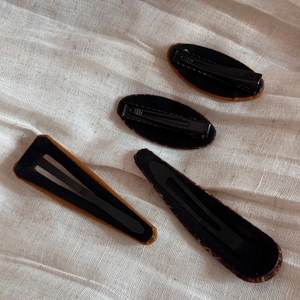 Detail view showing the back structure of fabric-covered metal BB hair clips in brown
