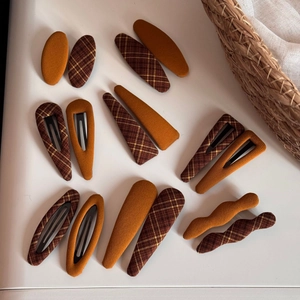 Vintage checkered and orange fabric hair clips set in various geometric shapes
