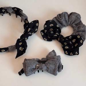 Detailed set of bow headband, scrunchie, and hair claw with grey mesh and floral patterns