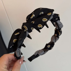 Detailed macro view of the non-slip inner teeth and paisley bow on the vintage headband