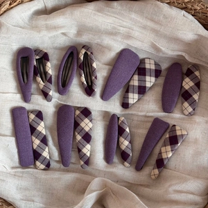 Flat lay detail of 16-piece purple fabric BB hair clips set with plaid patterns in a basket