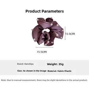 Detail view of large dark purple satin hair scrunchie with white pearl accents and 15.5cm size