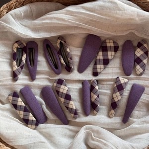 Detail of Korean style purple fabric hair clips set with diverse plaid patterns in a basket