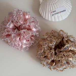 Detailed close-up of pink and bronze sequins lace double-layer silk scrunchies hair ties