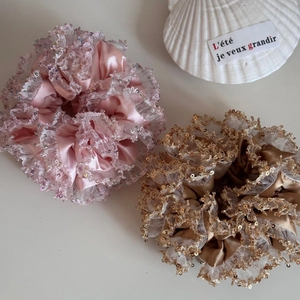 Close-up of pink and bronze lace scrunchies with shimmering sequins and silky texture