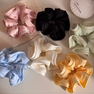 Set of 6 colorful satin scrunchies in pastel tones with a silky texture and ruffles