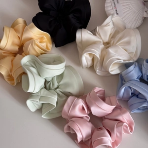 Detail of colorful satin scrunchies in pastel colors with high elasticity and elegant texture