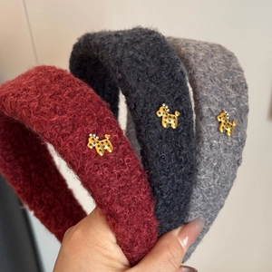 Detail of furry lamb wool headbands in three colors with golden puppy decorative buckles