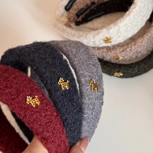Detailed view of plush teddy velvet headbands with golden terrier charms and stars
