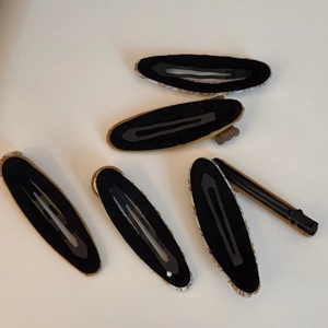 Detailed back view showing black felt lining on BB clips and duckbill hairpins