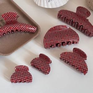 Detail showing various sizes of sweet strawberry plaid resin hair claws for women