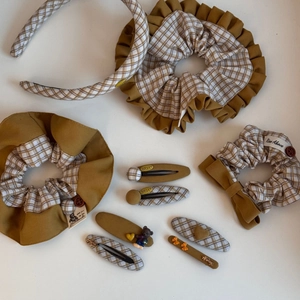 Detail of Korean-style fabric scrunchie and hair clip set with vintage plaid patterns