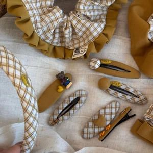 Close-up of autumn collection fabric scrunchies and hair clips with plaid patterns