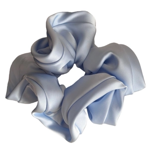 Elegant light blue satin scrunchie with a glossy silk texture and ruffled elastic design