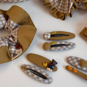 Detail of handmade fabric scrunchies and hair clips with resin bears and heart charms