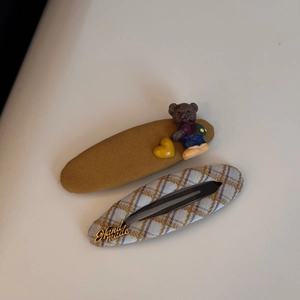 Detail of yellow bear hair clip and blue plaid handmade metal plate hairpin set