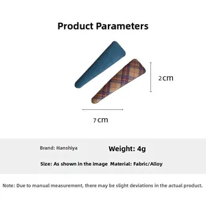 Detail view of plaid fabric hair clips showing 7cm length and 2cm width dimensions