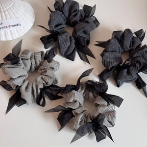 Set of four grey striped and solid fabric hair scrunchies with chiffon ribbon bows