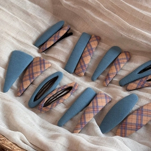 Flat lay of Korean plaid fabric hair clips in denim blue and multi-color patterns