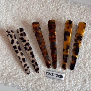 Set of 6 French leopard print and tortoiseshell acetate hair clips on soft white fabric