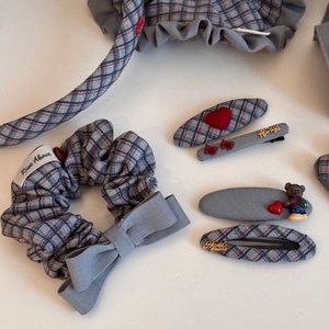 Detailed set of grey plaid scrunchies and hair clips featuring red hearts and a teddy bear
