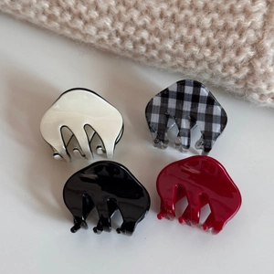 Set of four small acetate hair claws in white, black, red, and checkered patterns