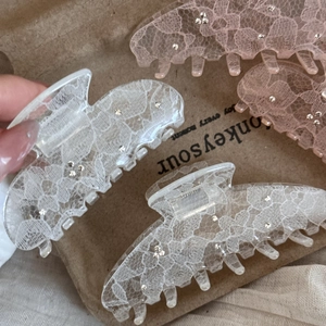 Lace textured hair claw clip with rhinestone accents for women available in pink and white