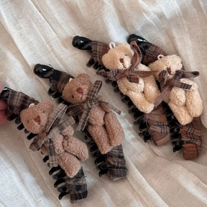 Dettaglio dei fermagli per capelli a forma di orsetto con fiocchi e trama morbida