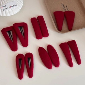 Detail of red fabric hair clips set featuring velvet texture and metal BB clips back