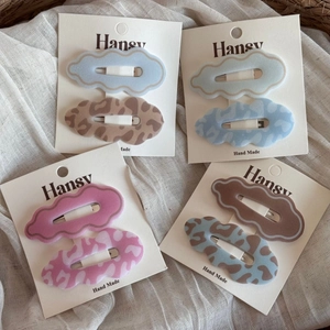 Set of 8 leopard print and cloud-shaped hair clips in matte blue, pink, and brown colors