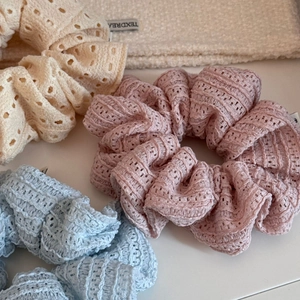 Detailed macro of hollow lace scrunchies in cream pink and light blue colors