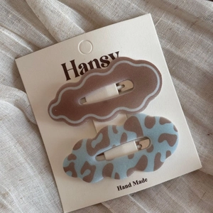 Close-up of leopard print and solid brown flocking wave BB hair clips on display card