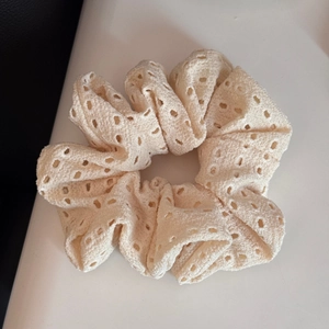 Detailed view of cream lace oversized hair scrunchie with intricate hollow embroidery